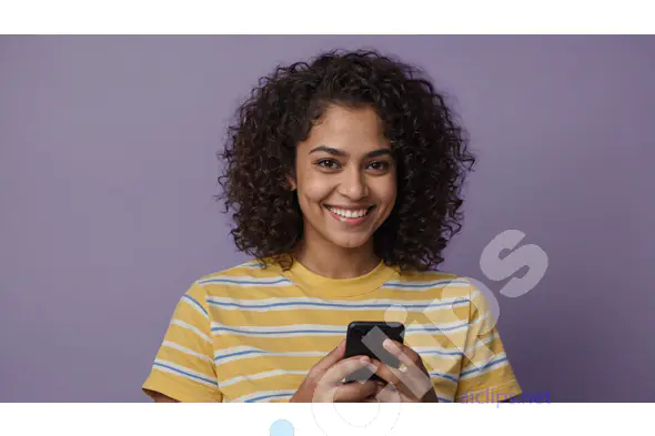 Smiling Woman with Curly Hair Using Smartphone in Yellow Striped Shirt