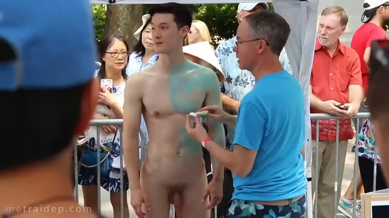 Naked handsome man acts as a model for an artist to paint his body