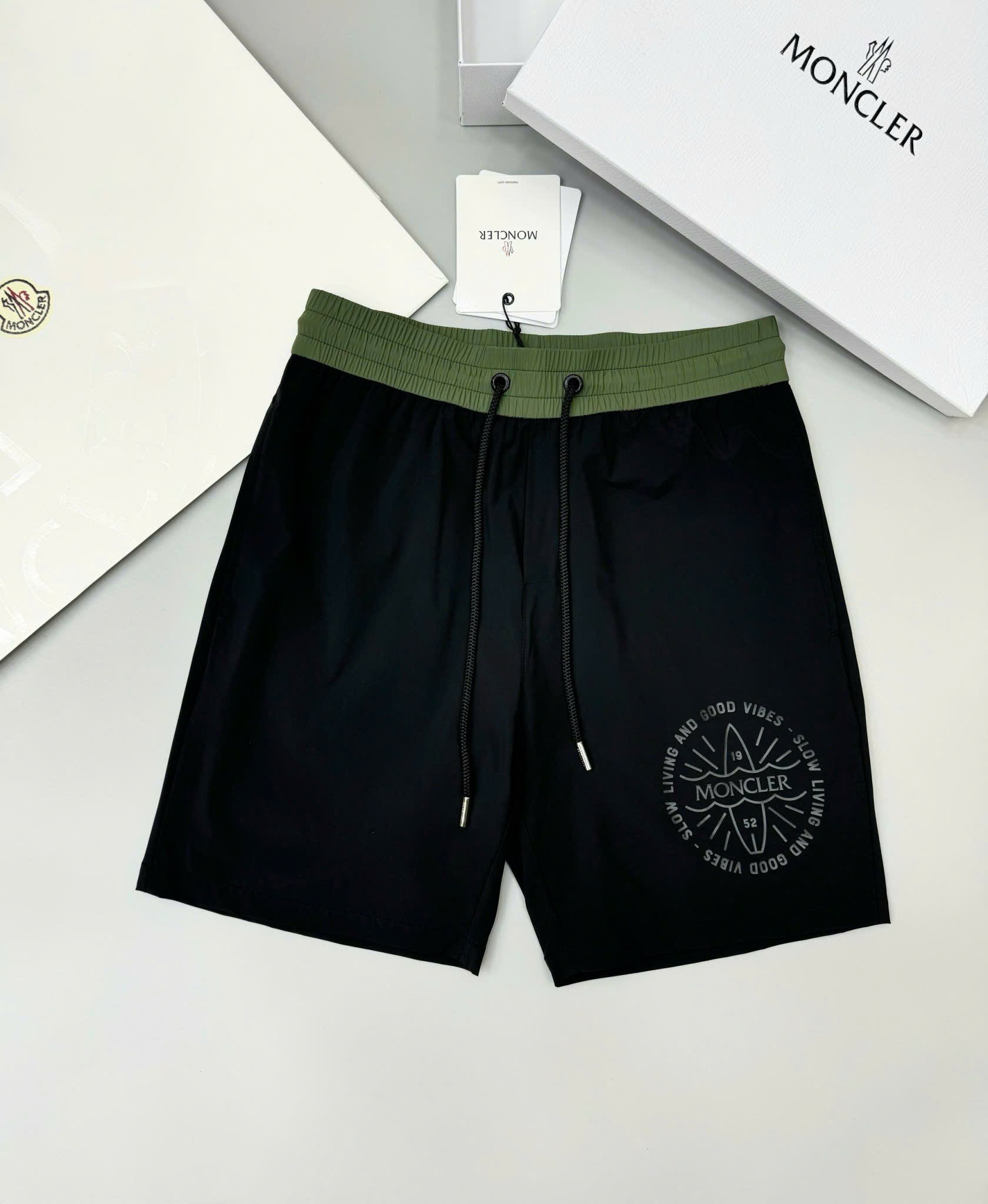 Quần short gió Moncler M logo tròn đùi phối cạp Like Auth 1-1 on web CD