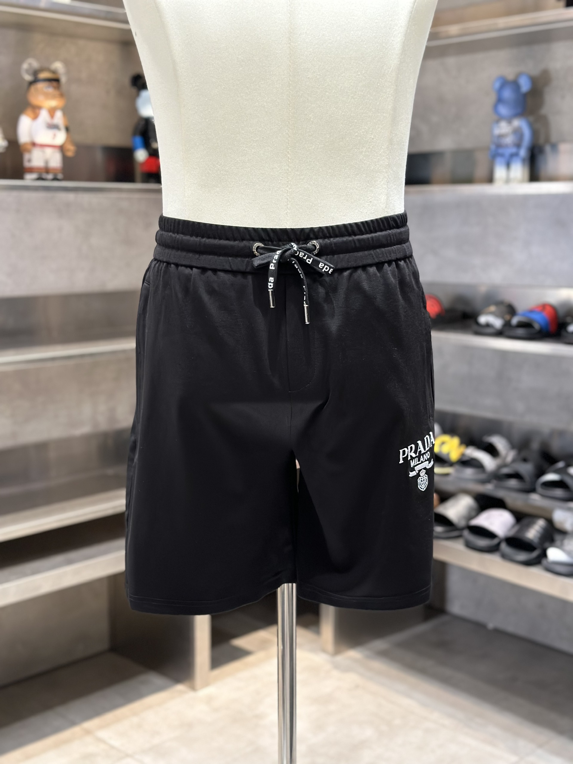 Quần short nỉ Prada P Đen logo chữ Trắng thêu đùi Like Auth VTN