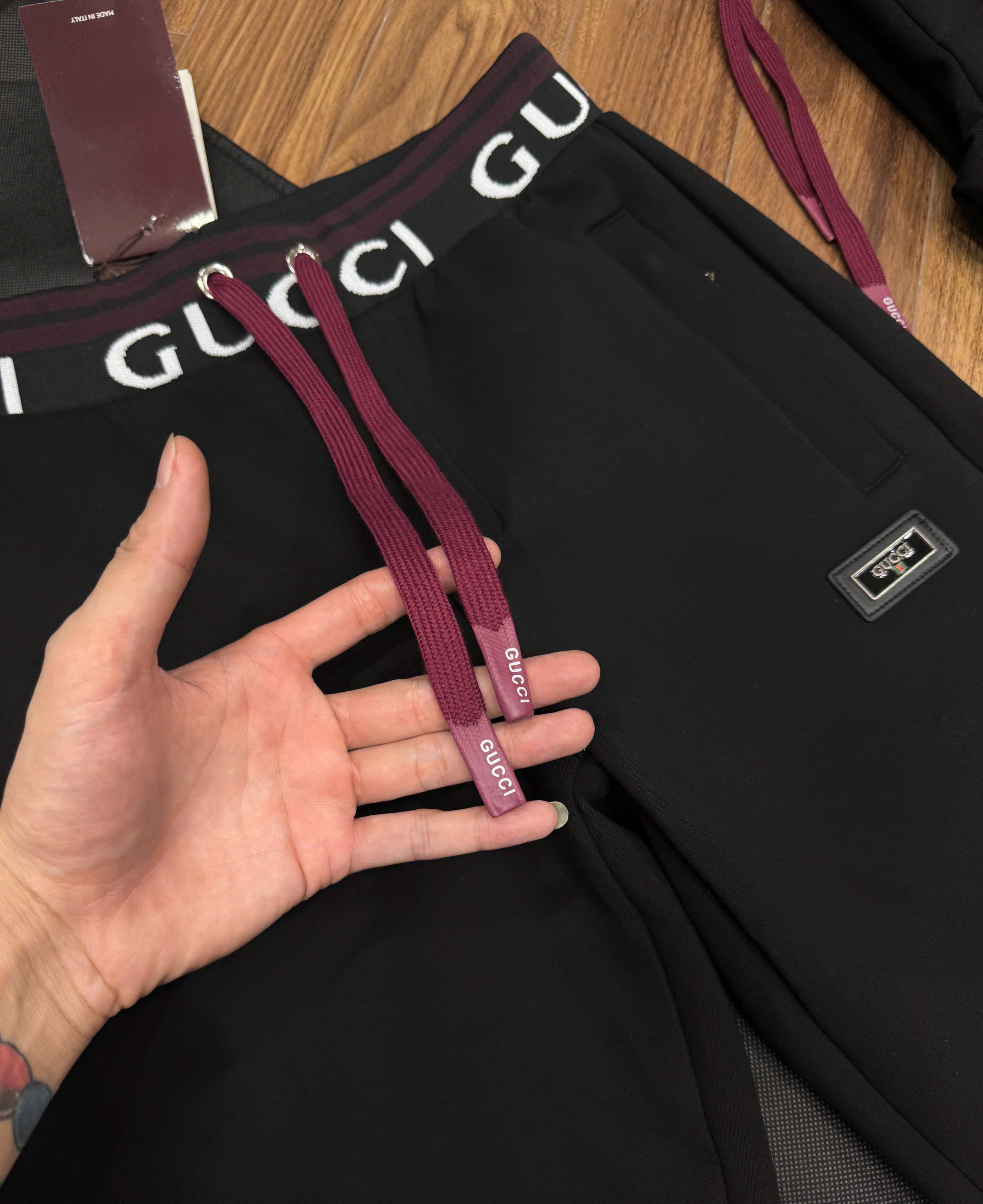 Quần jogger nỉ Gucci Đen logo chữ Trắng phối kẻ sọc dây Đỏ cạp Like Auth NV