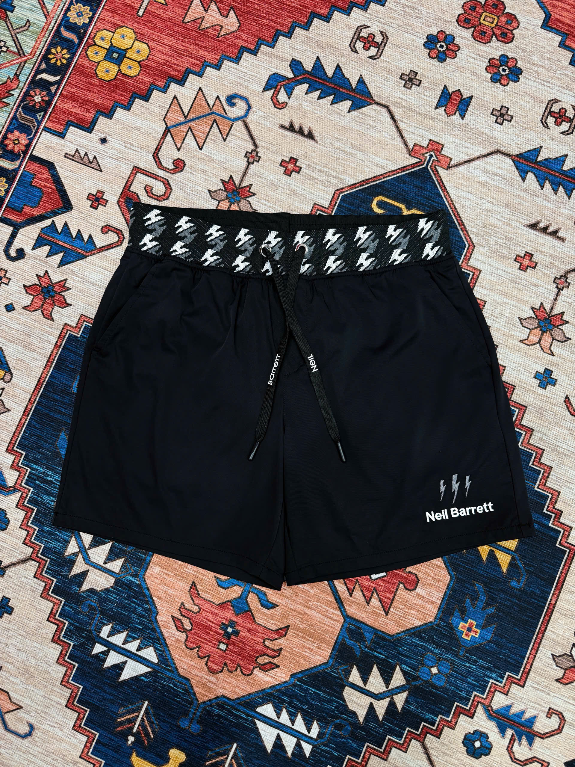 Quần short đùi gió Neil Barret check cạp logo thêu tia sét Like Auth S-XL MK