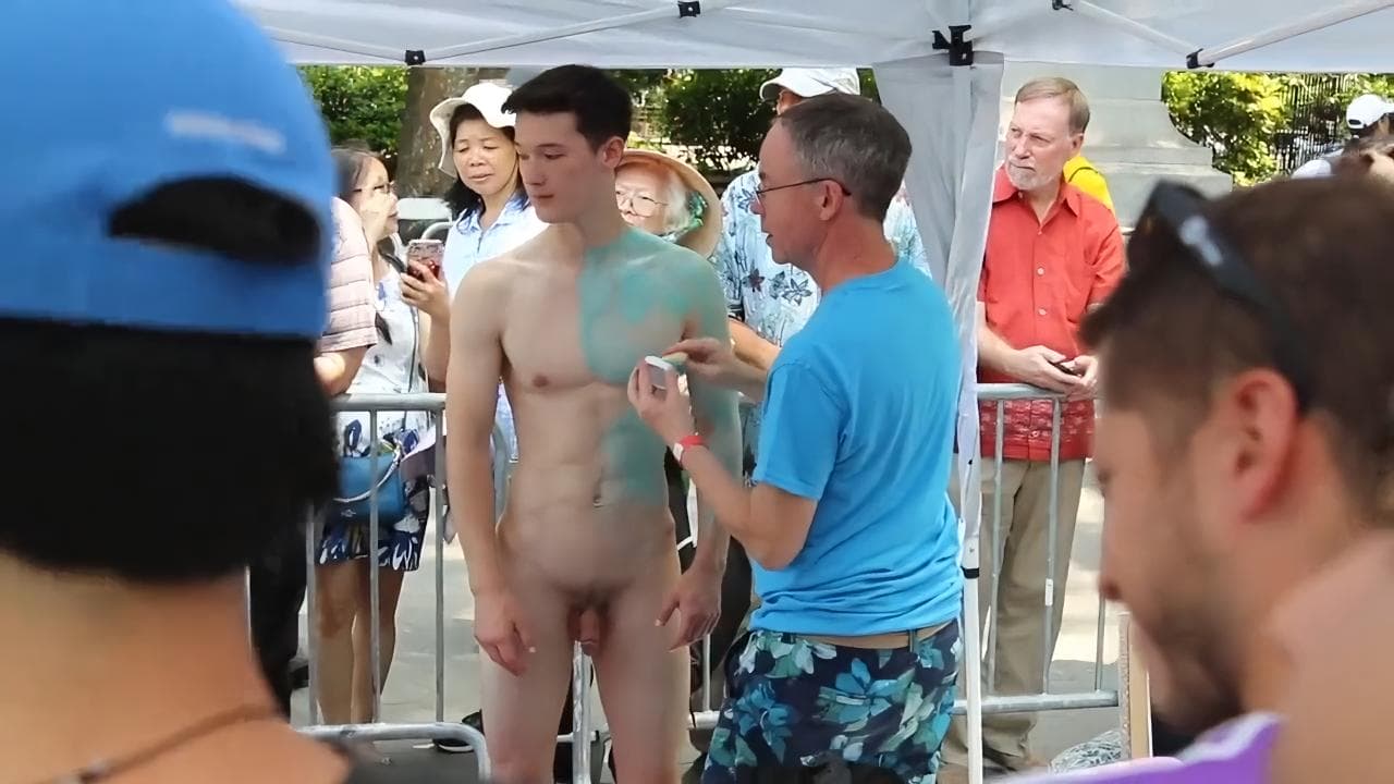 Naked handsome man acts as a model for an artist to paint his body sex gay